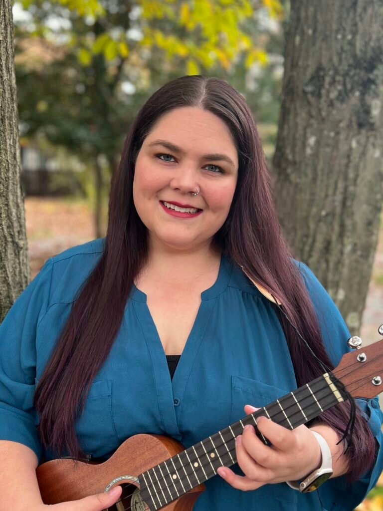 Musician woman smiling with ukulele